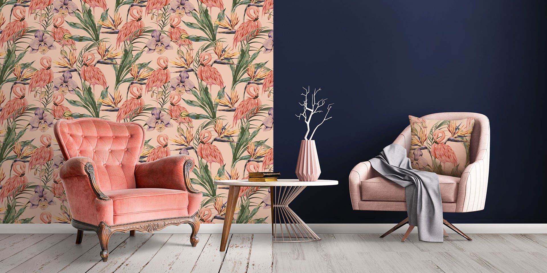 Pink chairs flank a table against floral and navy walls.