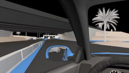 Driving view from inside a car under an overpass with palm trees visible