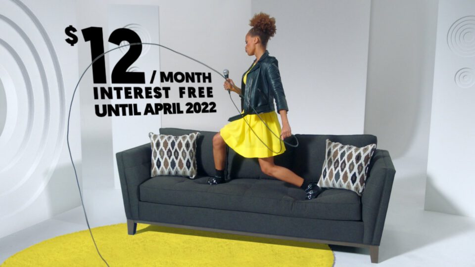 Woman jumping rope on sofa with $12/month interest-free offer text