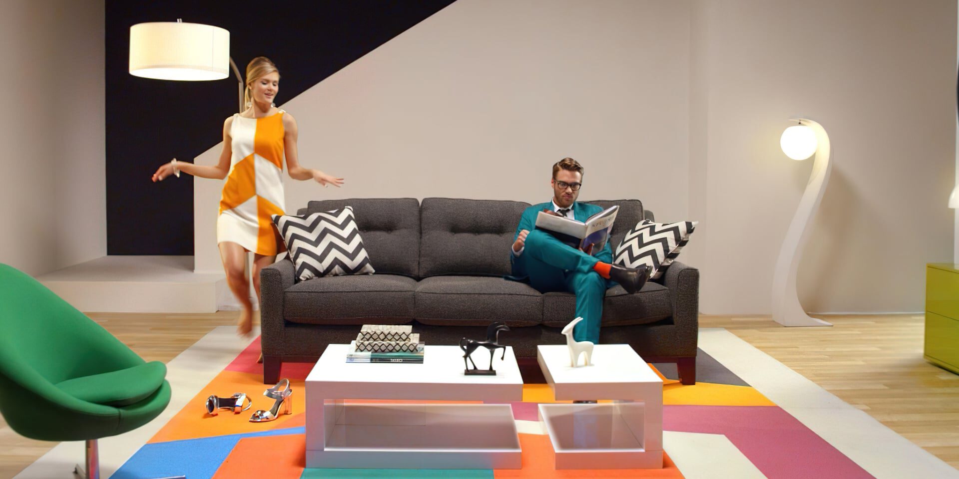 Modern living room with colorful furniture, a man reading, and a woman dancing.