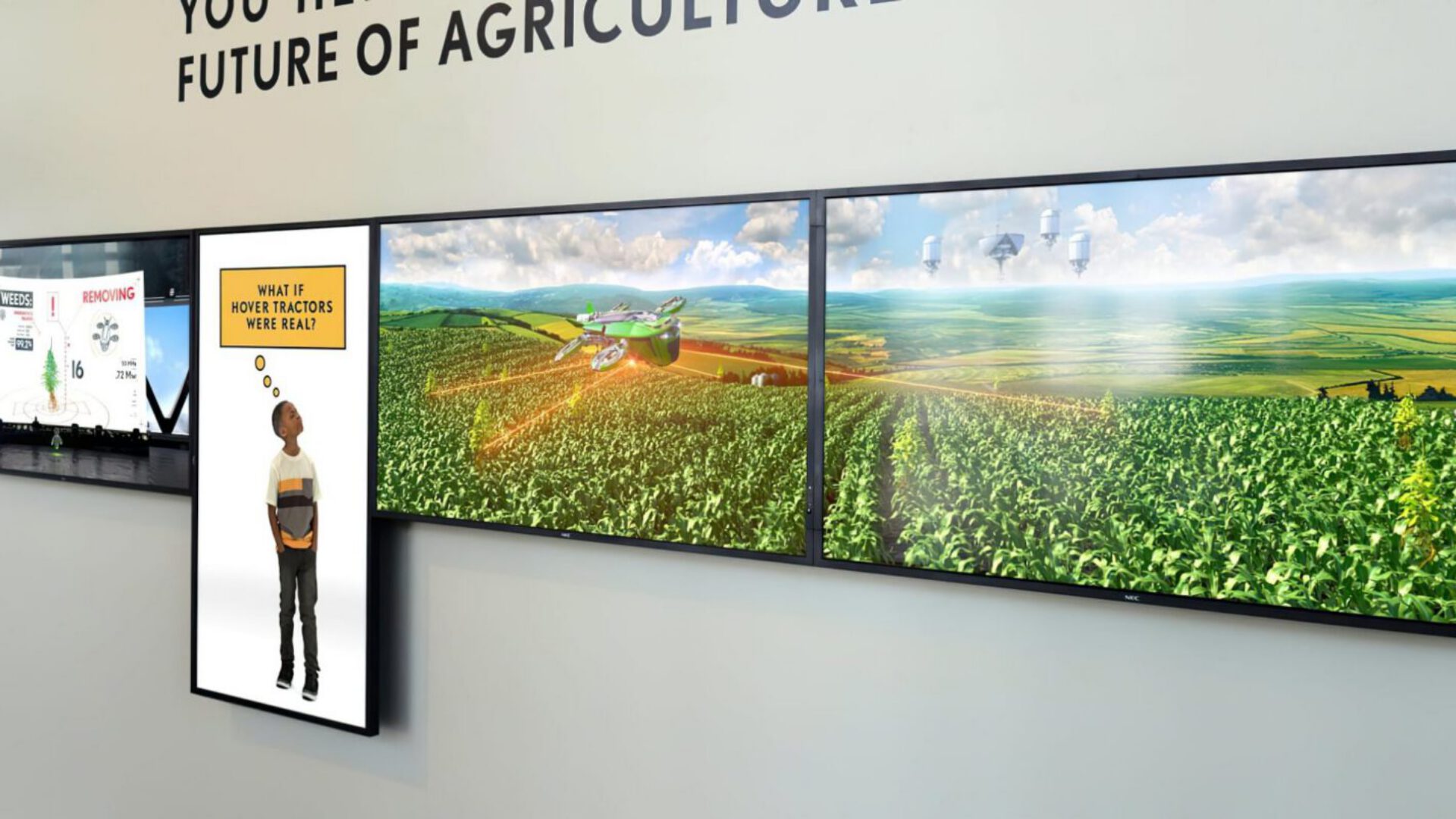 Interactive display showing future of agriculture with digital screens and green fields visuals.