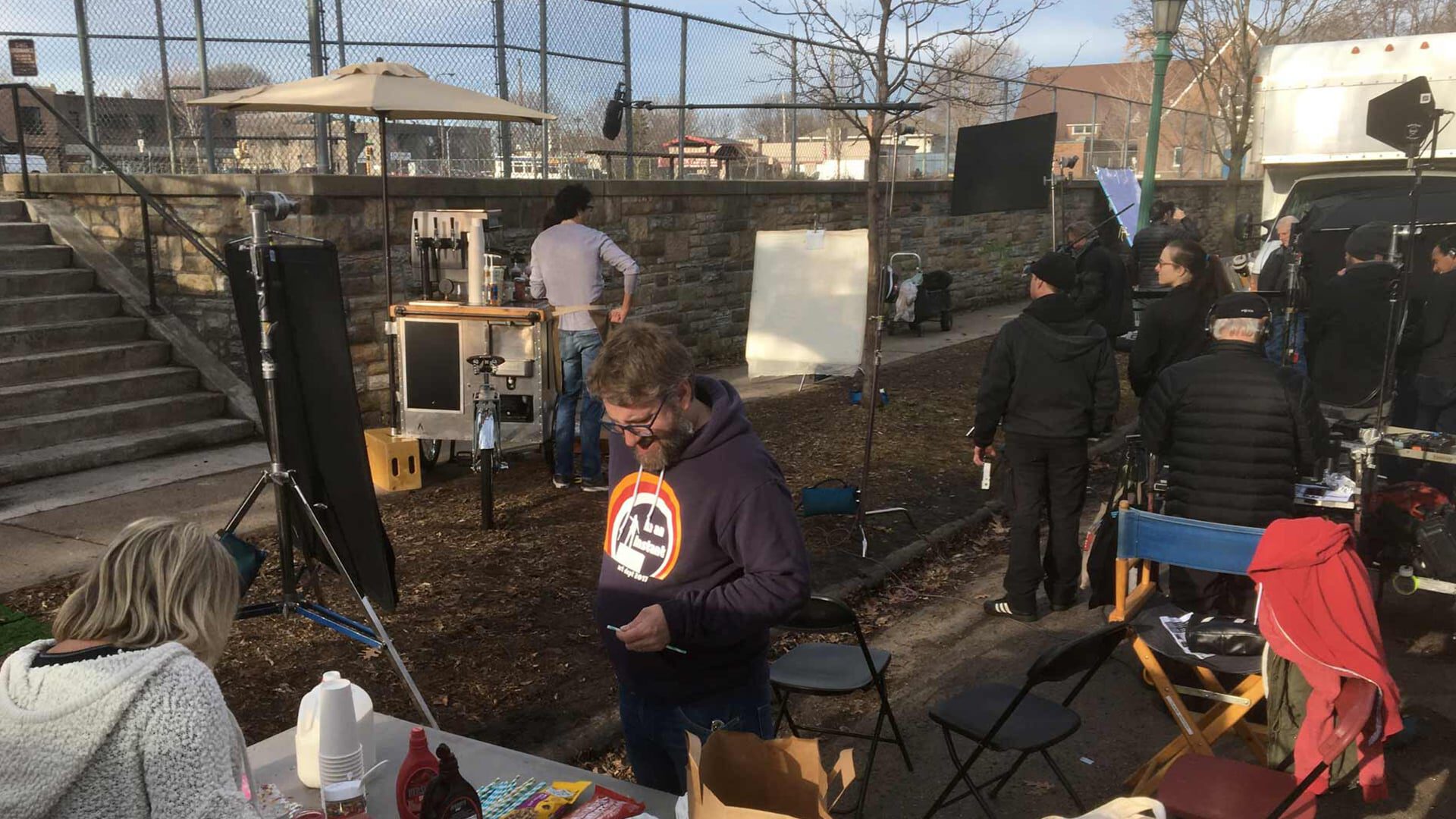 Film crew working outdoors with equipment and crew members