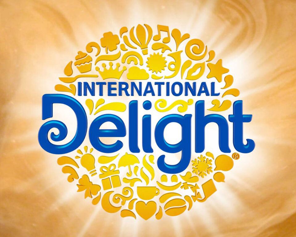International Delight logo with golden icons and warm background