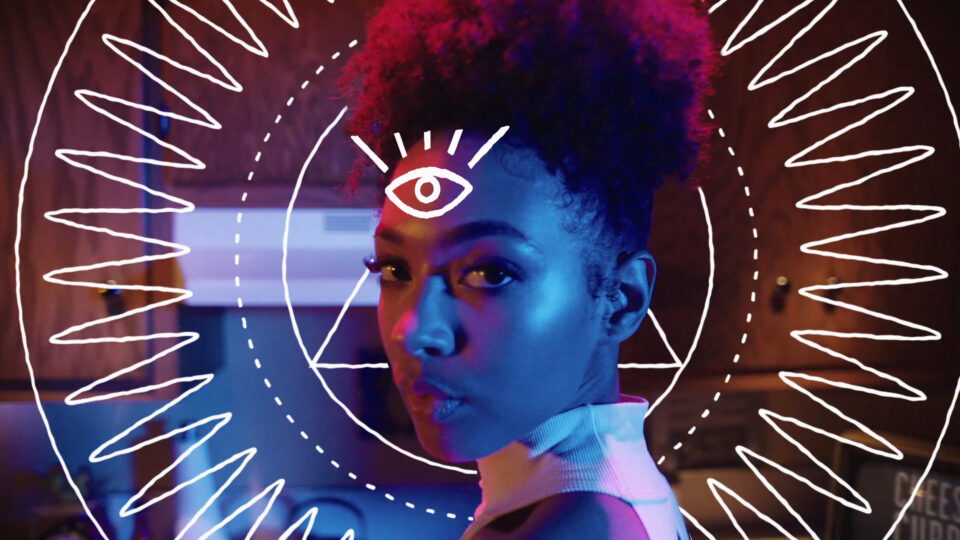 Woman with glowing eye symbol and neon patterns in futuristic setting