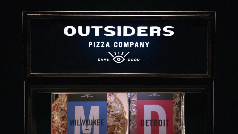 Outsiders Pizza Company sign with Milwaukee and Detroit pizza options