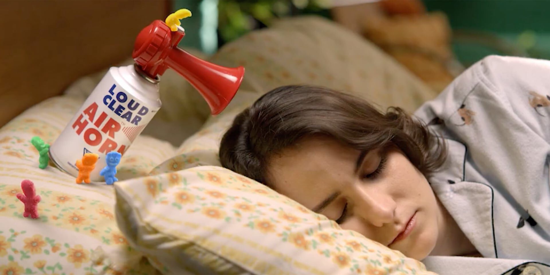 Sleeping person with a toy air horn beside them