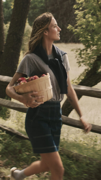 woman carrying apples