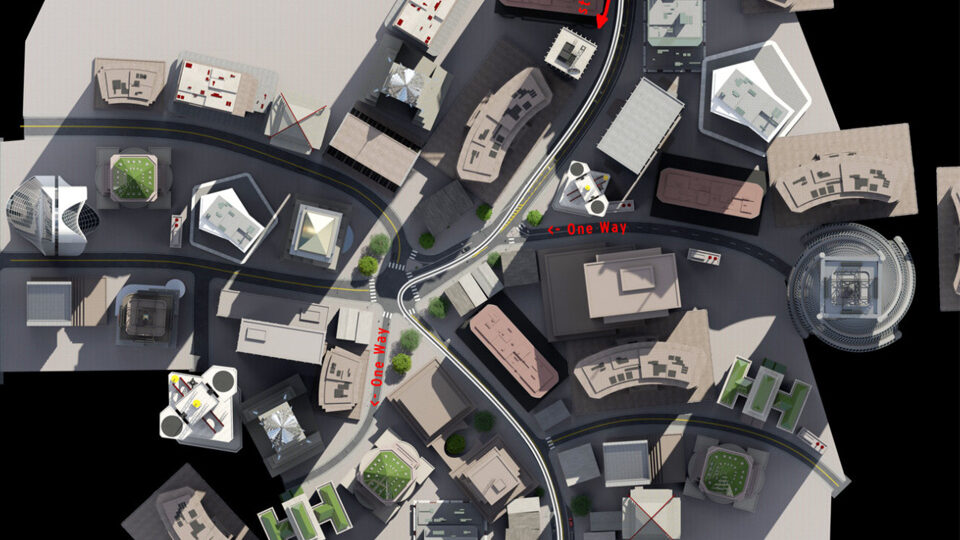 Top-down view of urban streets with one-way signs and modern buildings.
