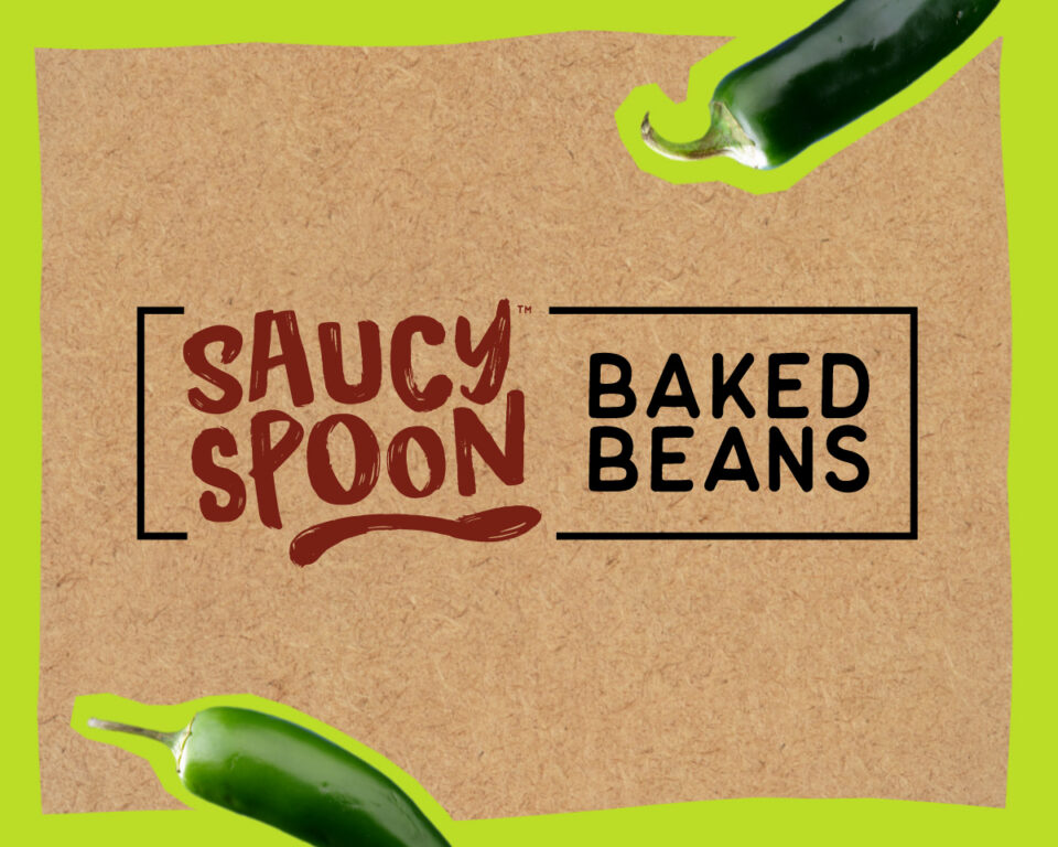 Saucy Spoon Baked Beans label with jalapeños on a cardboard background