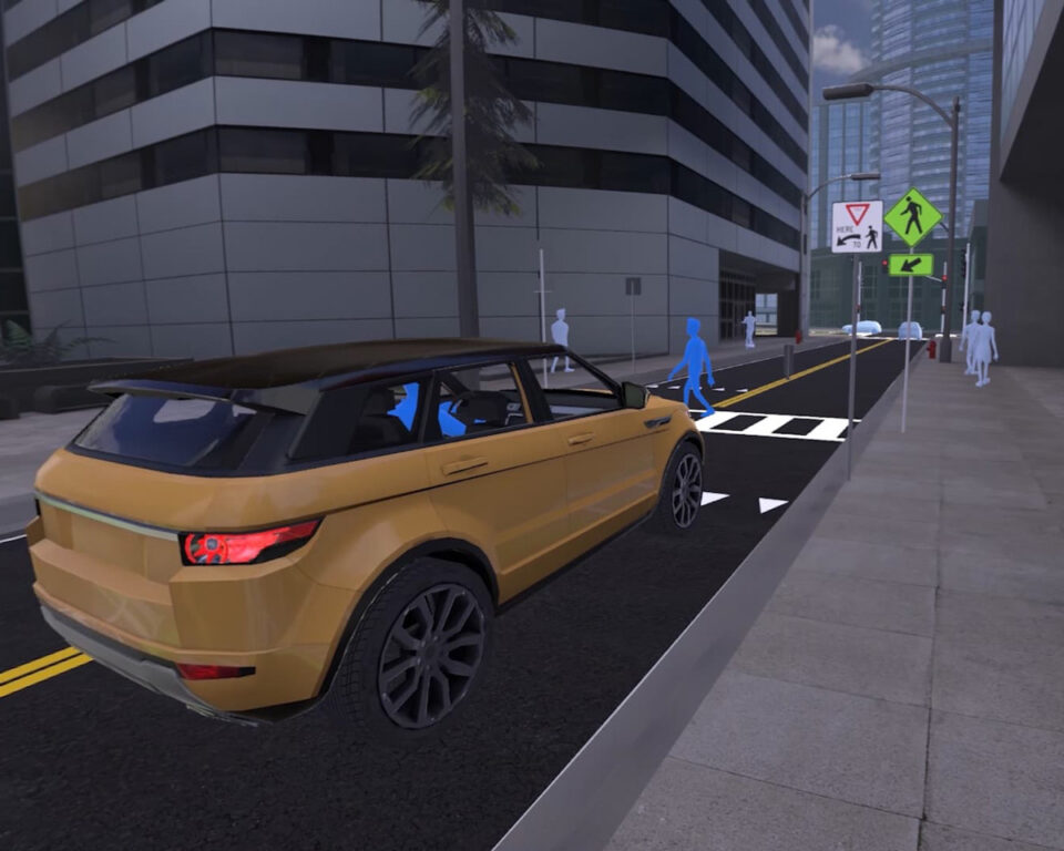 Gold CG SUV at crosswalk with pedestrian signals and sidewalk access