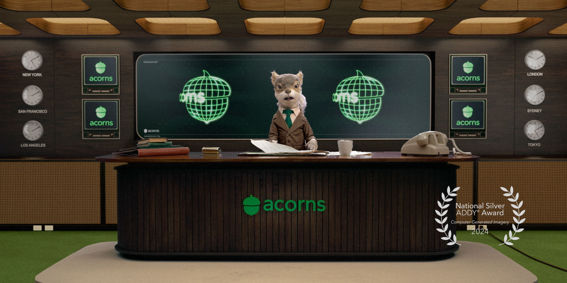 Squirrel puppet news anchor in studio with "acorns" branding and globe graphics