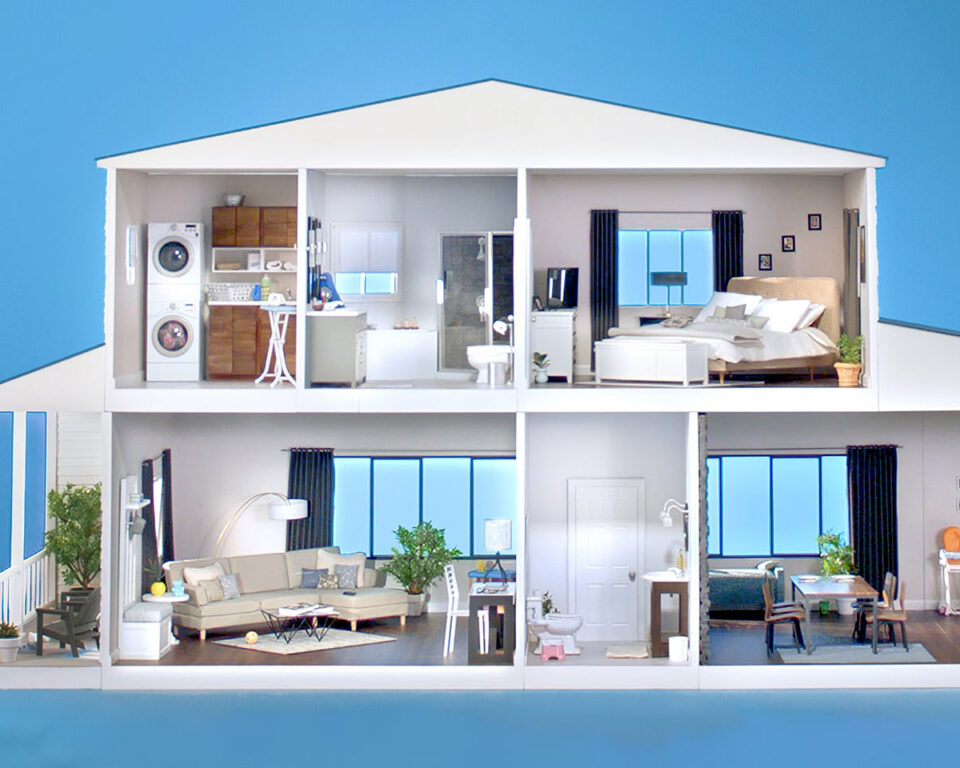 Detailed dollhouse with furnished rooms, including kitchen, living, and bedrooms.