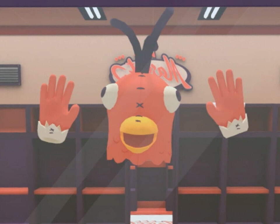 Orange cartoon bird mascot with hands raised, behind glass in a gym locker room