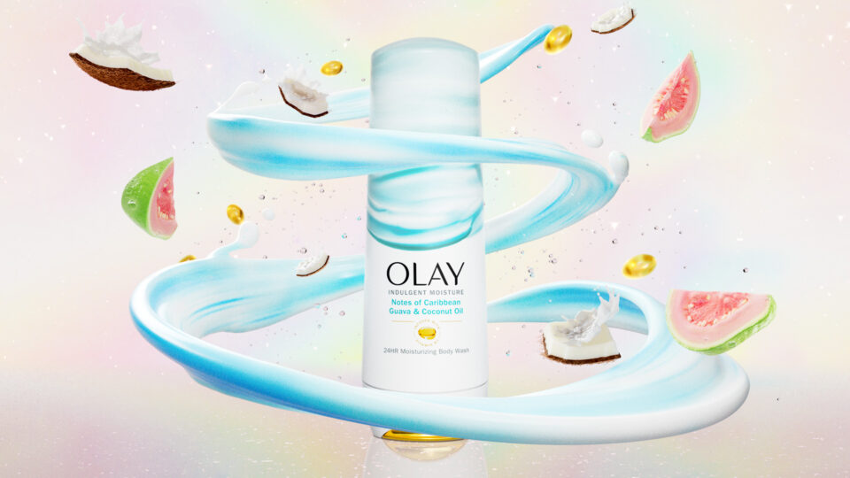 Olay body wash bottle surrounded by swirling blue liquid and floating fruit slices.