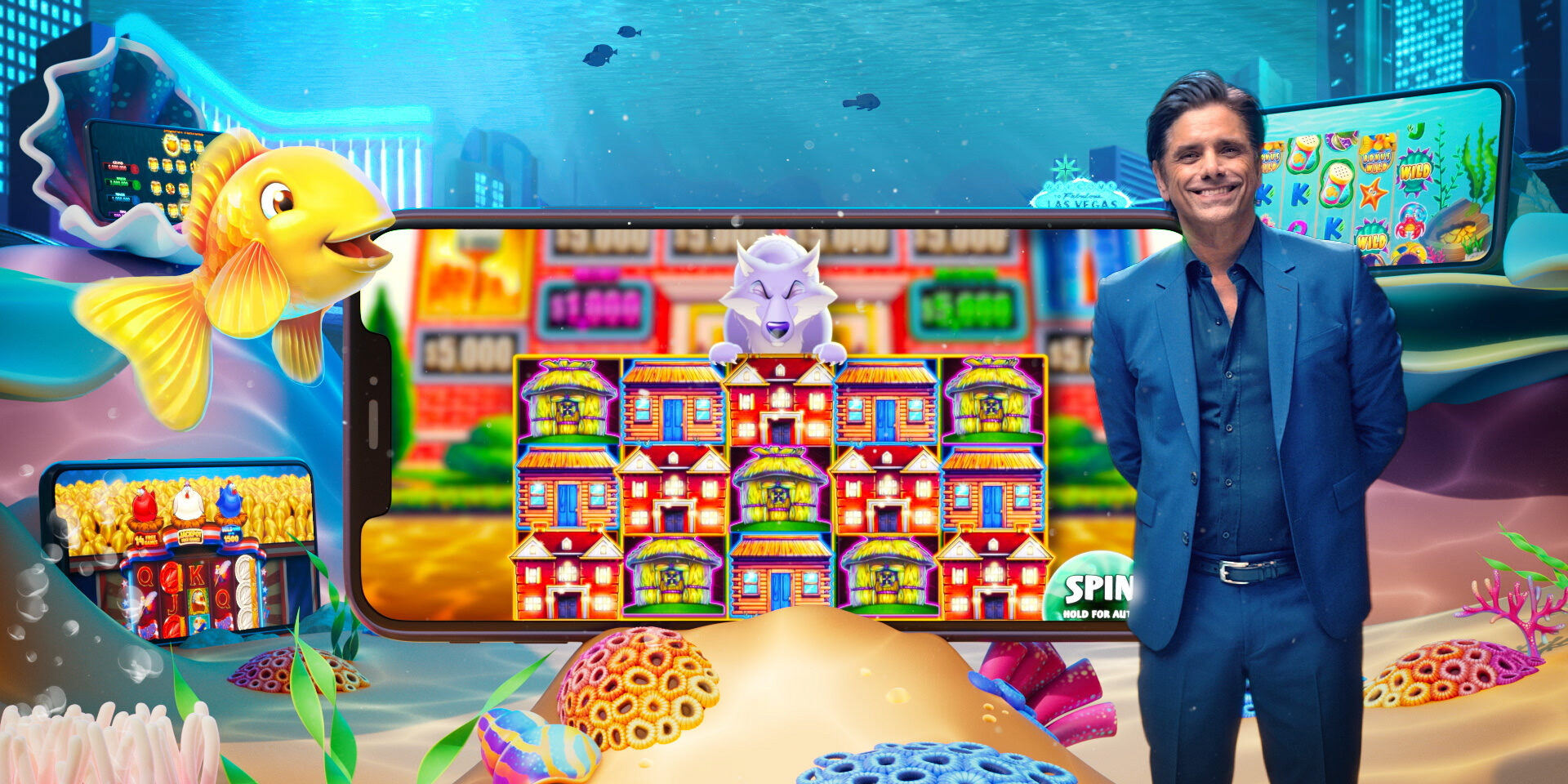 John Stamos in suit stands beside vibrant underwater-themed slot machine display