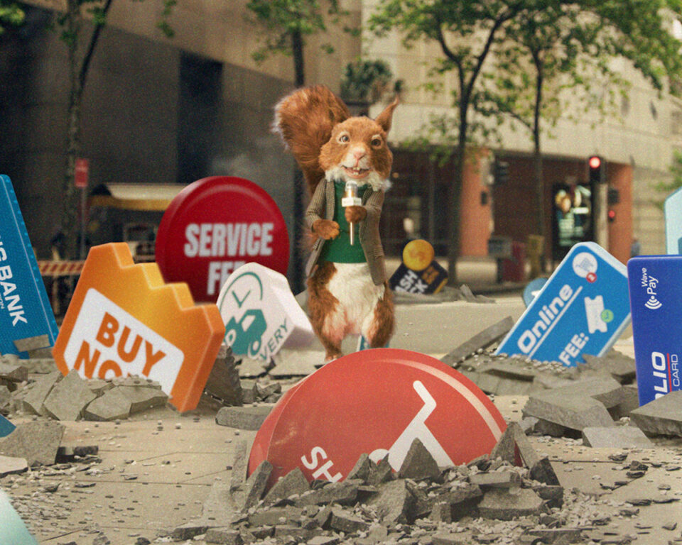Squirrel puppet reporter amidst rubble of financial fee signs